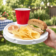 White MingleEasy plate with sandwich, chips and red cup seated in built-in drink holder, held by the rim